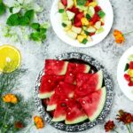 A colorful array of fresh fruit salad with watermelon and citrus, top view.